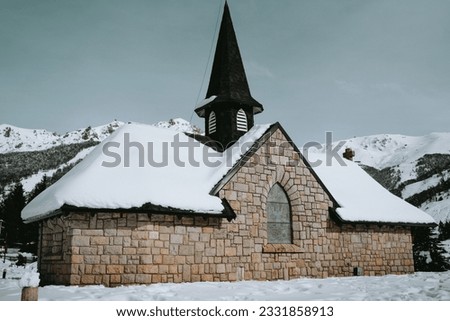 Beautiful old church full of snow amidst mountains at Cerro Catedral