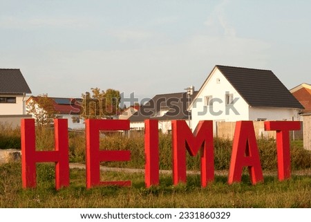 Home Letters in front of Houses. Symbol picture to welcome refugees in Germany - text translation "home"