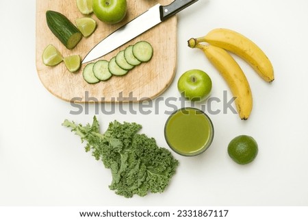 Top down view of healthy lifestyle green smoothie made with fruit and vegetables on a white background. Lifestyle concept.