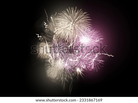 A large bright fireworks display event with gold and pink rocket breaks.