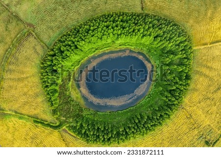 Aerial view of beautiful lagoon in the Azores islands. Drone landscape view with lines and textures in the background. Top view of volcanic crater, tourist attraction of Portugal.