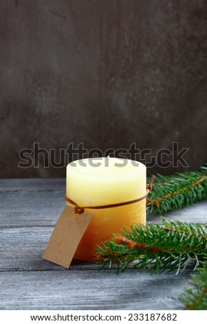 Christmas candle with pine branch on the boards, xmas
