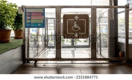 Accessible Elevator with sign. Disabled persons lift near modern apartment facility. The special elevator for the disabled at the entrance to the living house. Equipment with the wheelchair..
