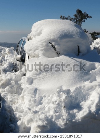 car covered in snow. car under the snow