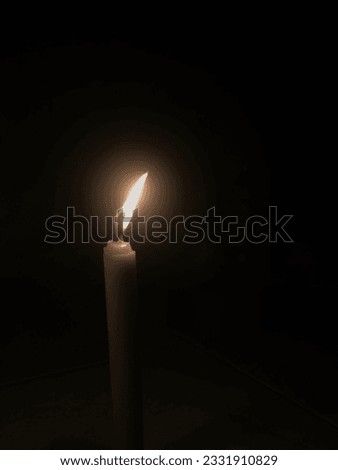 a newly lit candle with fire