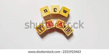 New year word in wooden cubes concept isolated on white background.