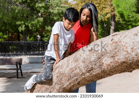 Happy mother and son enjoying together outdoors in a park.