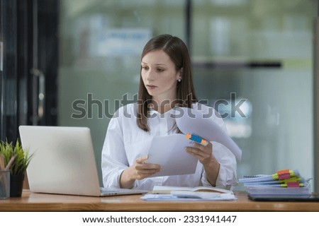 A businesswoman and accountant read reports for information, financial data, or analysis. Documents, auditor, and happy female professional check contracts, review, and bookkeeping in the office. Royalty-Free Stock Photo #2331941447