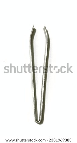 This picture is a picture of a tweezers with silver color. (8 July 2023, Medan - Indonesian)