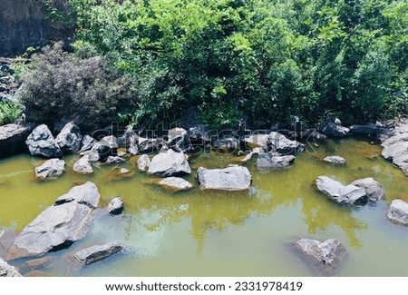 Calming photo of resting rocks by the riverside