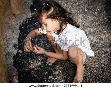 Cute child present editing filter effect of portrait image. Little girl clear face focusing at camera. Dress wearing black and white. Glorious look with close up hand style behind blur background.