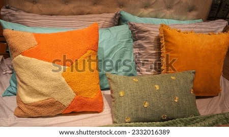 picture of sofa cushions arranged on a bed with full color