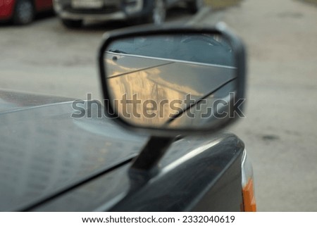 Rear view mirror. Mirror on car is mounted on hood. Overview for driver. Old Car Parts. Royalty-Free Stock Photo #2332040619