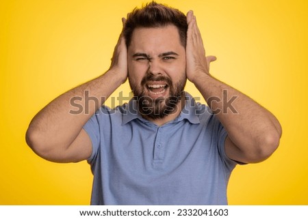 Dont want to hear and listen. Frustrated annoyed irritated caucasian man covering ears gesturing No, avoiding advice ignoring unpleasant noise loud voices. Handsome guy alone on yellow background Royalty-Free Stock Photo #2332041603