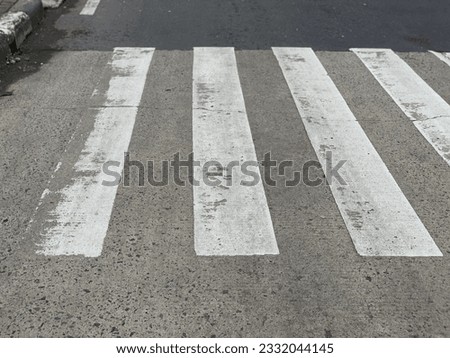 a zebra crosswalk stands as a symbol of safety and order amidst the urban landscape