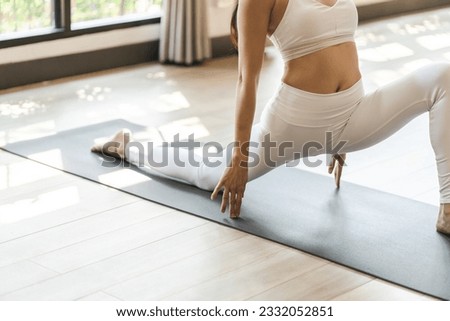 Fitness asian woman doing yoga stretching exercise on mat yoga fitness exercises. Healthy lifestyle Calmness and relax at yoga studio Royalty-Free Stock Photo #2332052851