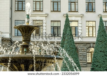 Fountain with clear water on the background of the house.