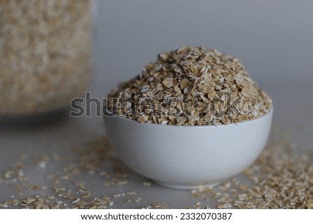 A bowl full of quick oats or quick cooking oats. They are rolled oats that go through further processing to decrease cooking time. They have a mild flavour and soft, mushy texture. Royalty-Free Stock Photo #2332070387