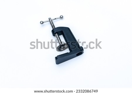 Black table lamp clamp on white background.