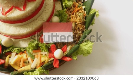 Cone Shaped Rice with Indonesian National Ribbon called Nasi Tumpeng Merah Putih For Independence Day Celebration at 17 August Royalty-Free Stock Photo #2332109063