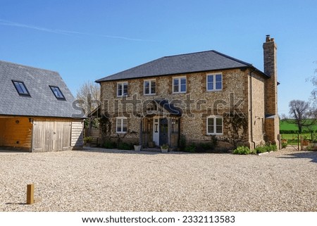 Beautiful house in rural England. Exterior of detached country home  Royalty-Free Stock Photo #2332113583