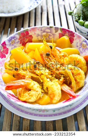 Thai food, yellow curry with big shrimps and jusmine rice