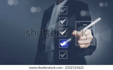 Businessman check mark electronic document review, approval, authentication on business documents on the virtual interface Royalty-Free Stock Photo #2332125621