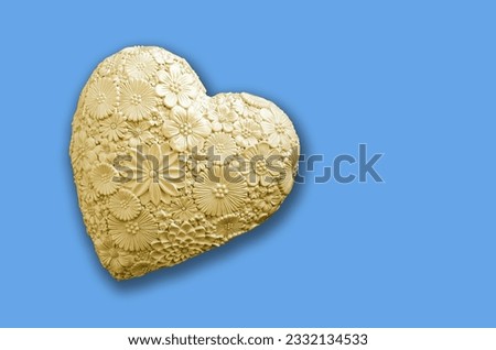 yellow plaster heart on a blue background. holiday concept. place for text
