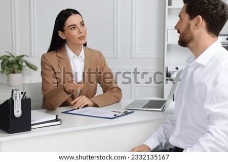 Human resources manager conducting job interview with applicant in office Royalty-Free Stock Photo #2332135167