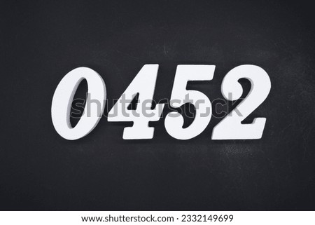 Black for the background. The number 0452 is made of white painted wood.