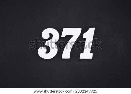 Black for the background. The number 371 is made of white painted wood.