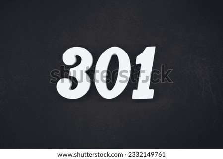Black for the background. The number 301 is made of white painted wood.
