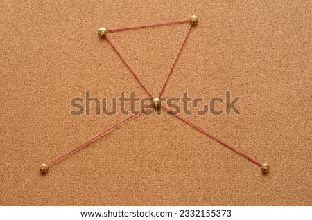 Corkboard detective with pins and thread Royalty-Free Stock Photo #2332155373