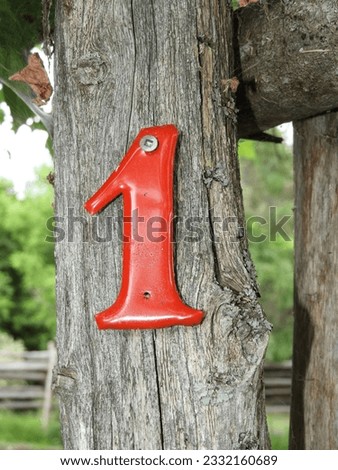 Number 1 in Red on an Old Fence Post