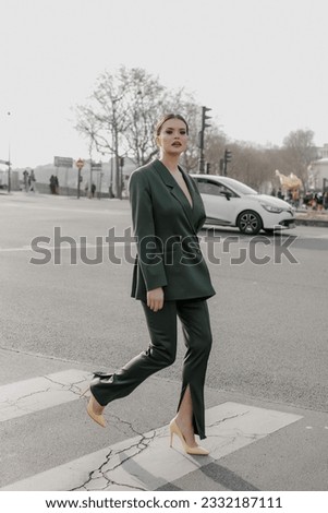 A beautiful young stylish girl is walking in Paris