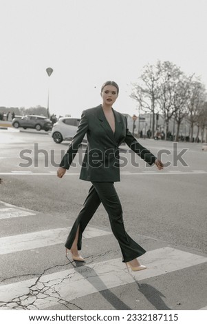 A beautiful young stylish girl is walking in Paris