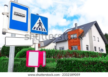 Road signs and modern houses with blue sky background. Concept of real estate in Luxembourg . European bus station