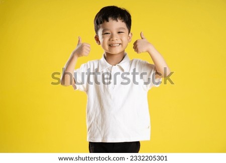image of asian boy posing on a yellow background
 Royalty-Free Stock Photo #2332205301