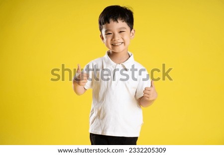 image of asian boy posing on a yellow background
 Royalty-Free Stock Photo #2332205309