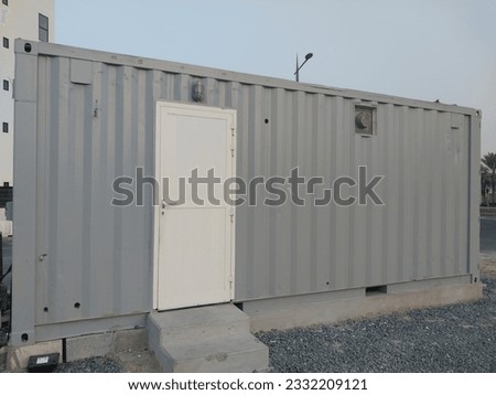 Container, Gray color container with white color access door furnished for living or staying inside container or cabin, Portable Home or house for residence