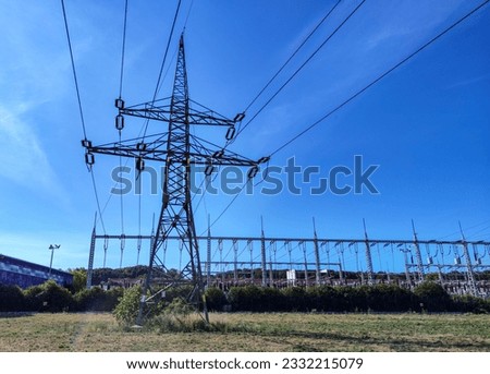 Transmission towers against the blue sky. Powerful electricity pylons.
