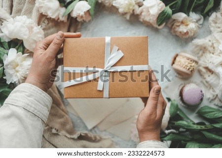 Gift box in hands, holiday concert.