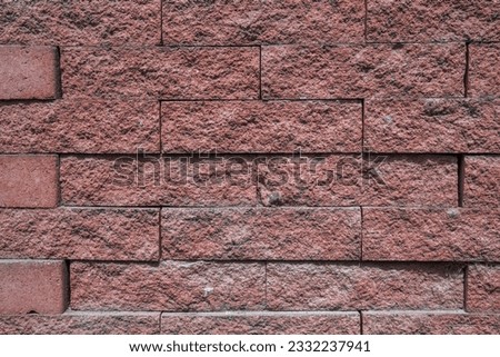 texture of a wall with red stone bricks with a grungy relief