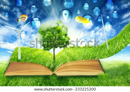 communication technology high tech social media symbol icon fly in green micro world. Book covered with green grass wind energy turbine. Sustainable source electricity concept. Eco friendly approach