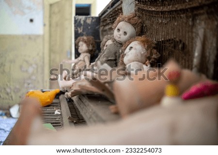 Interior decoration of abandoned private houses with piano and dolls in the exclusion zone of Belarus.