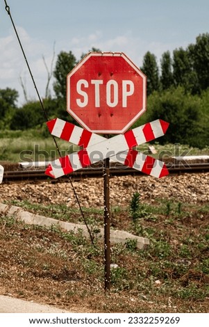 stop sign attention railway tracks with a small station outside the city outside the village