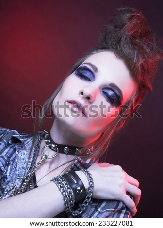 Punk. Young woman with smokey eyes and with artistic hairstyle.