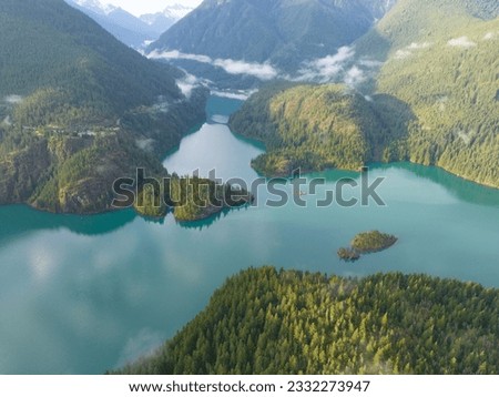 Rugged, forest-covered slopes surround Diablo Lake in North Cascades National Park. This mountainous region of northern Washington is absolutely beautiful and easily accessed during summer months. Royalty-Free Stock Photo #2332273947