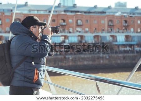 Traveler photographer taking photos at Puerto Madero's canal in Buenos Aires, Argentina. Copy space