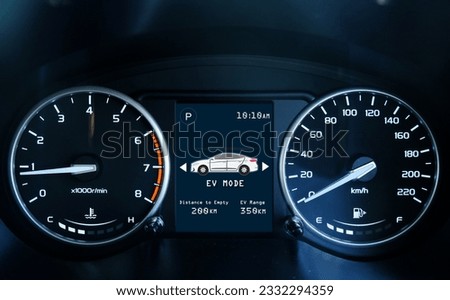 A low light picture with noise effect of car dashboard meter with indicator and EV mode. Car hybrid and electric concept